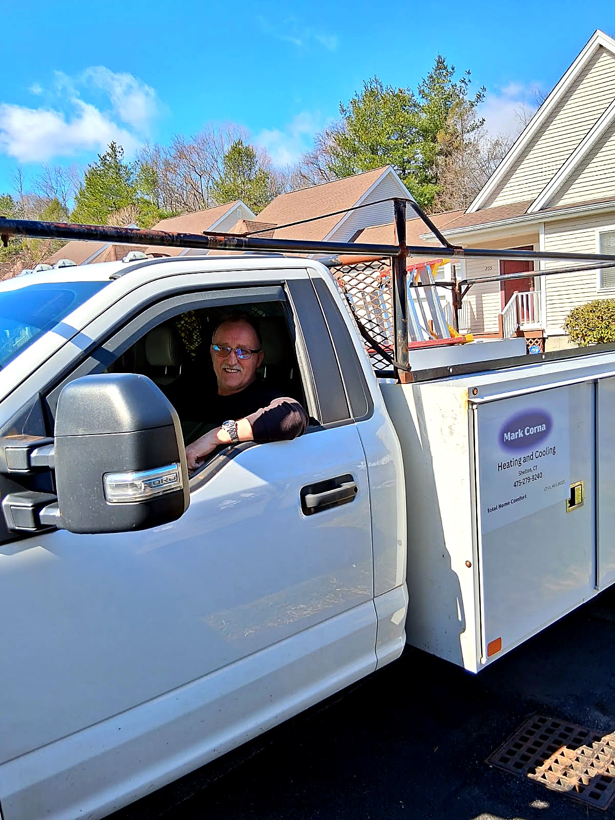 Mark Corna in his Mark Corna Heating and Cooling service truck in Shelton, CT